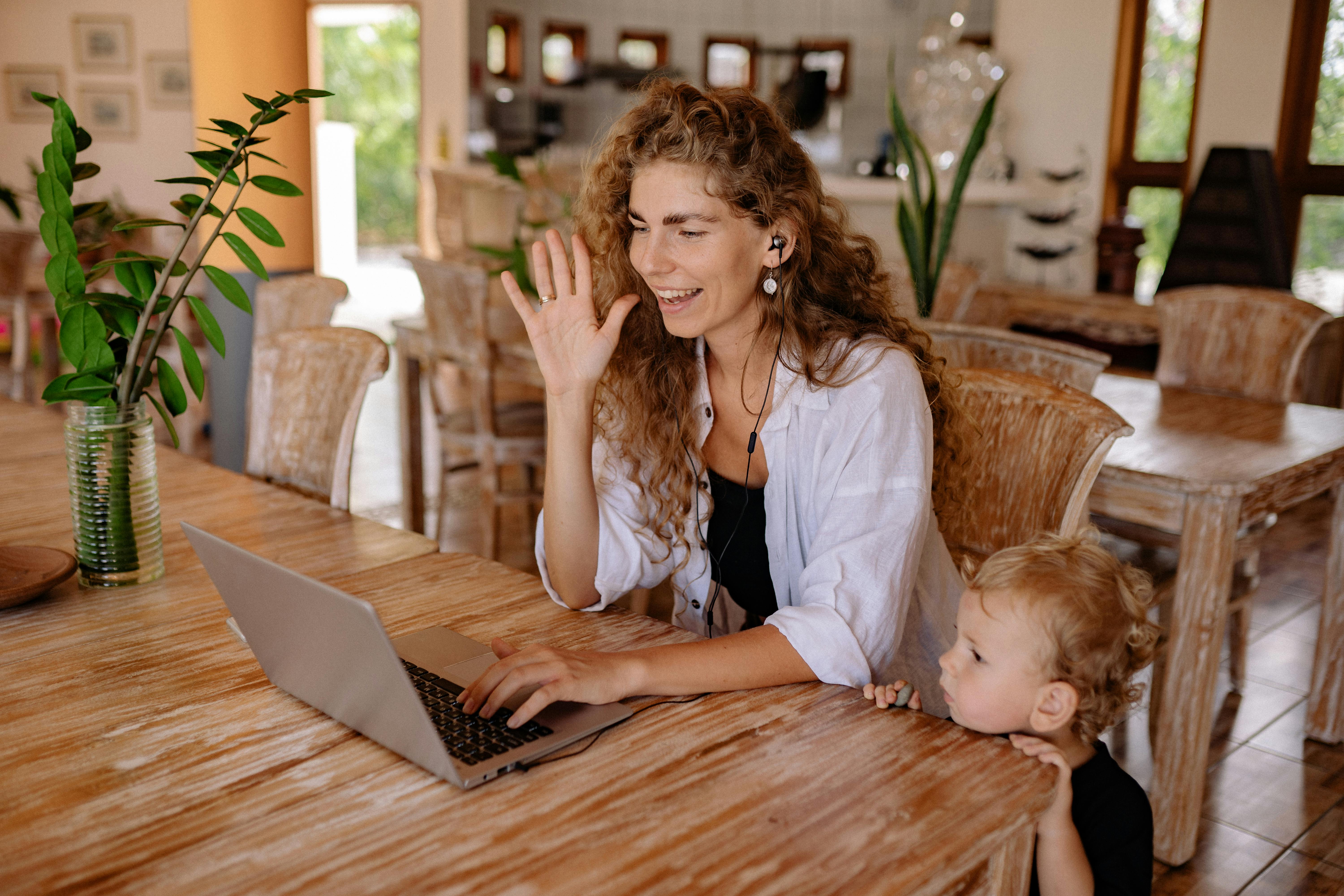 Woman in front of laptop with child